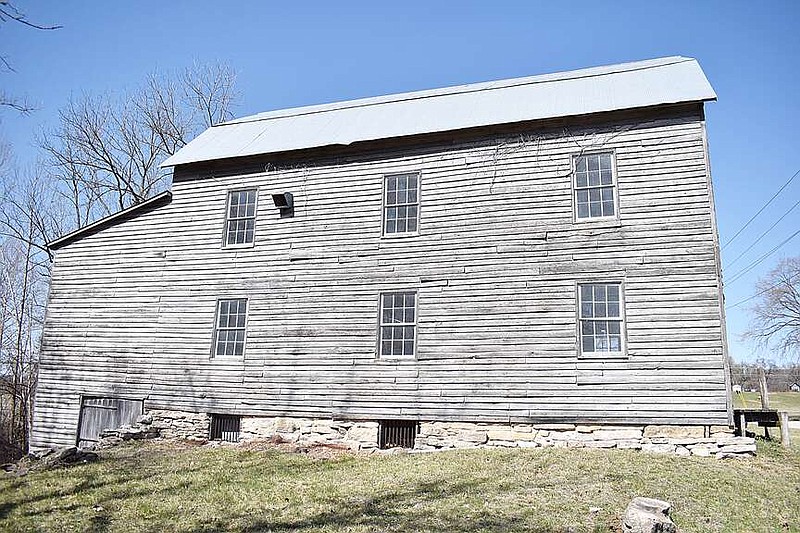 Democrat photo/Garrett Fuller — This unassuming wood building seen March 10 along Hopewell Road near the Moniteau Creek in southern Cooper County was once the core of a community. This grist mill, eventually known as Dick's Mill, was constructed in 1868 to mill wheat and corn into flour, cornmeal, and livestock feed. A general store, blacksmith shop and school sprouted around the mill, supported by people waiting around for their wheat and corn to be processed. In 1906, a post office was established — officially naming the small shortly-lived community Cotton. The mill closed during World War II and fell into disrepair until 1976, when two California men — Jim Martin and Paul Bloch — stepped in and saved it from ruin. Now, the Missouri River Valley Steam Engine Association is taking on the project of moving the mill to its Brady Showgrounds near Overton, where it will be restored to operation.