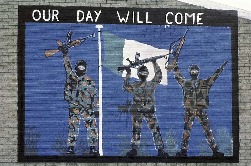 A wall painting supporting the Irish Republican Army is seen in November 1985 in the Catholic area of Belfast, Northern Ireland. A seven-year investigation into the activities of a former Irish Republican Army double agent concluded Friday, March 8, 2024, that the spy was probably responsible for more deaths than lives saved during Northern Ireland's three-decade conflict. The probe, known as Operation Kenova, investigated the actions of “Stakeknife,” a senior IRA member who was passing information to British intelligence during “the Troubles.” (AP Photo/Peter Kemp, File)