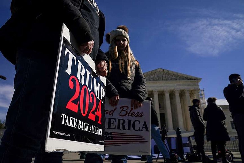 People demonstrate outside the U.S. Supreme Court in February. (Jahi Chikwendiu/The Washington Post)