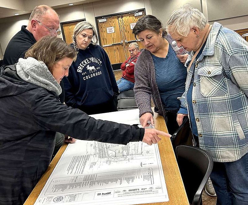 Annette Beard/Pea Ridge TIMES
Several people, including City Council member NadineTelgemeier and Police Chief Lynn Hahn, perused the plans for the Casey's General Store planned for the northwest corner of It'll Do Road and Slack Street.