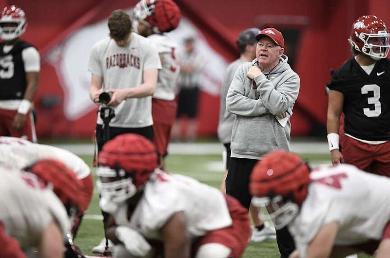 Arkansas assistant coach Bobby Petrino watches his players Thursday during practice inside the Willard and Pat Walker Pavilion on the university campus in Fayetteville. (NWA Democrat-Gazette/Andy Shupe)
