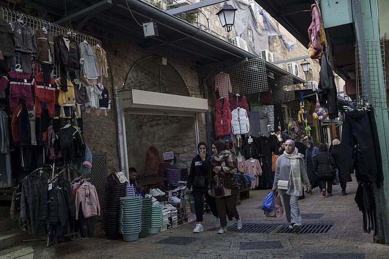 File - Muslim women walk through a market, ahead of the holy Islamic month of Ramadan, in the Old City of Jerusalem, Thursday, March 7, 2024. Restrictions put in place amid the Israel-Hamas war have left many Palestinians concerned they might not be able to pray at Al-Aqsa Mosque compound, which is revered by Muslims. (AP Photo/Leo Correa, File)