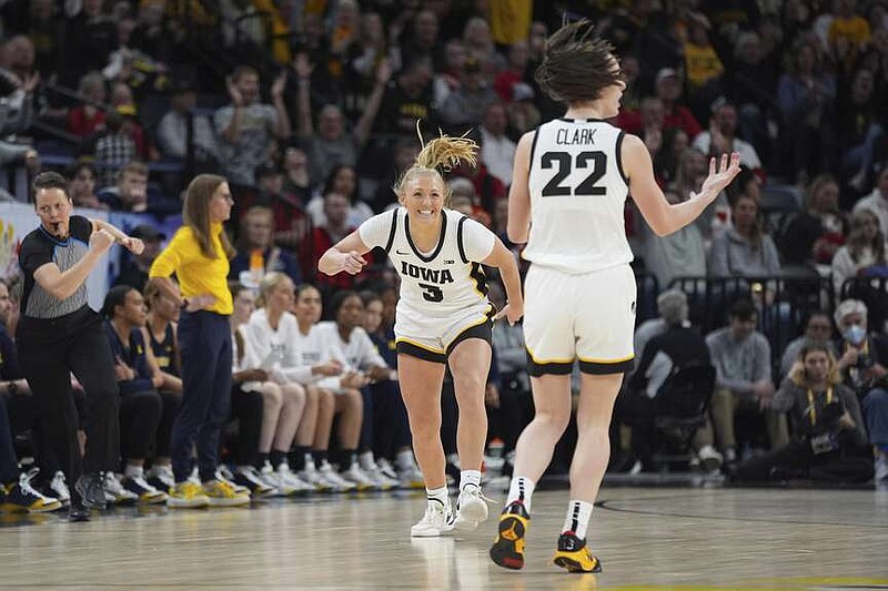 Iowa guard Sydney Affolter (3) celebrates toward guard Caitlin Clark (22) after making a 3-point basket during the first half of an NCAA college basketball game against Michigan in the semifinals of the Big Ten women's tournament Saturday, March 9, 2024, in Minneapolis. (AP Photo/Abbie Parr)