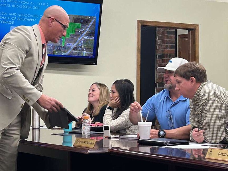 Prairie Grove Mayor David Faulk uses his tablet Feb. 26 to show City Council members Chris Powell and Doug Stumbaugh a parking lot downtown that the city is considering buying.

(NWA Democrat-Gazette/Lynn Kutter)