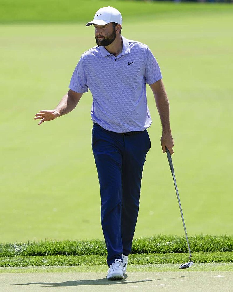 Scottie Scheffler waves to the gallery after sinking a birdie putt on the first hole during the final round of the Arnold Palmer Invitational golf tournament Sunday, March 10, 2024, in Orlando, Fla. (AP Photo/John Raoux)