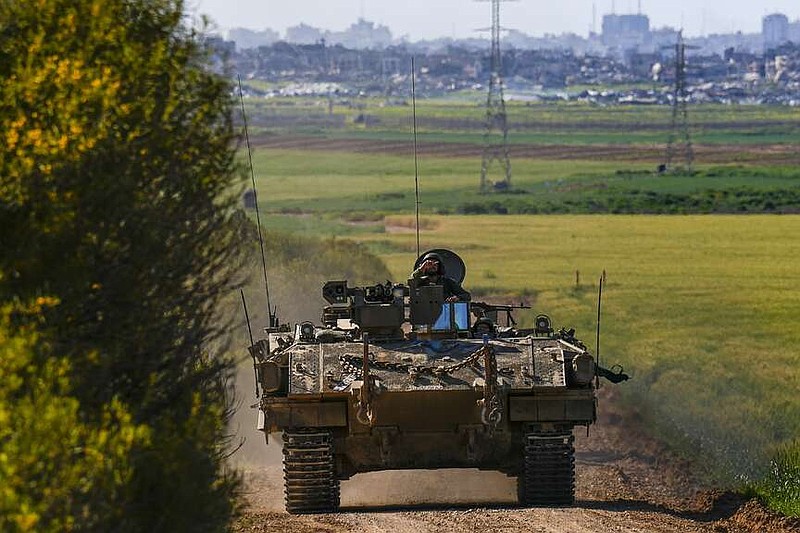 Israeli soldiers drive an APC near the border with Gaza Strip, in southern Israel, Sunday, March 10, 2024. (AP Photo/Ariel Schalit)
