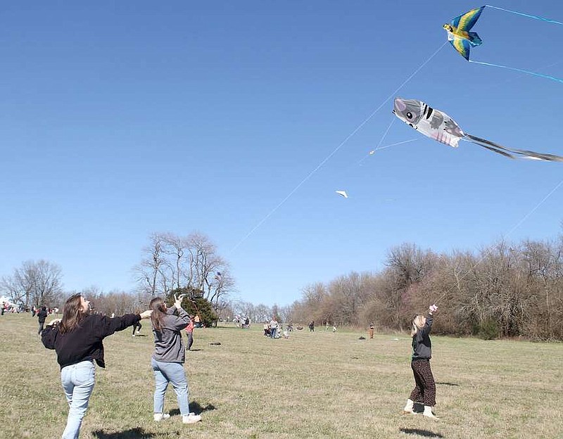 Cameron Barr (left), Catilin Sullivan and Faith Williamson, friends from Rogers, fly kites at the Cane Hill Kite Festival on Saturday, March 9. People of all ages showed up for the annual event, sponsored by T.A. Sampson at Springhill Ranch.