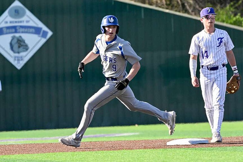 Rogers' Jacob Watson rounds second base during a baseball game on Monday, March 11, 2024, at Bulldog Stadium Fayetteville. The Fayetteville Bulldogs hosted the Rogers Mounties in a conference matchup. Visit nwaonline.com/photo for today's photo gallery. (NWA Democrat Gazette/Caleb Grieger)