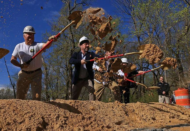 Dignitaries including Brad Moore, far left, and Saline County Judge Matt Brumley, second from left, participate in a ground-breaking ceremony for the restoration of the Old River Bridge to its original location over the Saline River in Benton on Monday, March 11, 2024. The bridge, constructed in 1891, will be the oldest in Arkansas in its original location once completed which is expected to take place later this year. (Arkansas Democrat-Gazette/Colin Murphey)