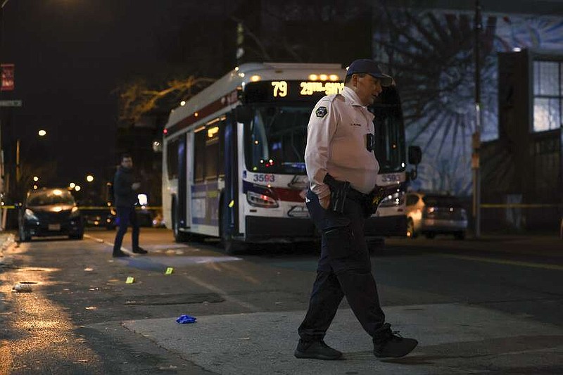 Police respond to a shooting on a SEPTA bus in South Philadelphia on March 5, 2024. A law enforcement official says the driver and a suspected gunman are in custody in the shooting of eight Philadelphia high school students at a bus stop. The official on Monday, March 11, 2024 says police continue to look for two juveniles who were also seen jumping out of the car last week and running toward the bus stop with the 18-year-old suspected shooter. (Heather Khalifa/The Philadelphia Inquirer via AP, file)