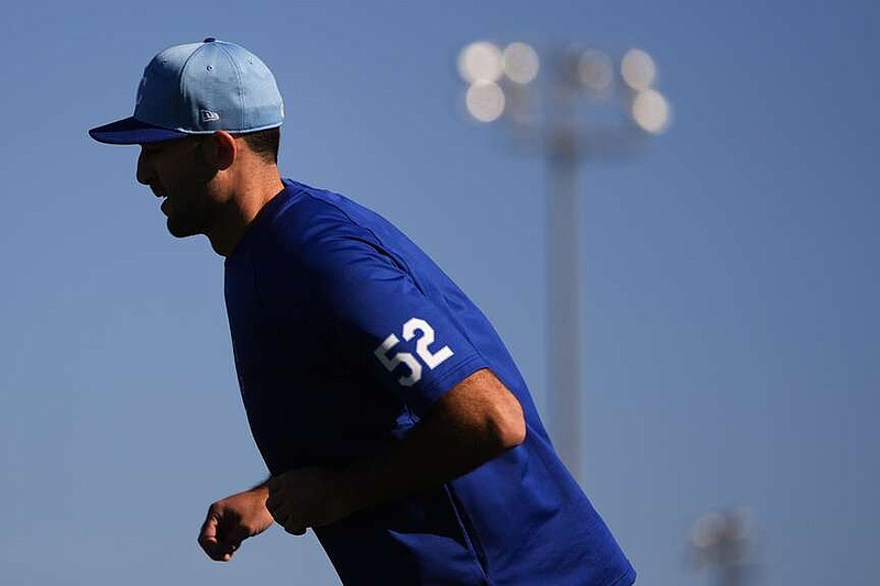 Kansas City Royals pitcher Michael Wacha warms up during spring training workouts Friday, Feb. 16, 2024, in Surprise, Ariz. (AP Photo/Lindsey Wasson)