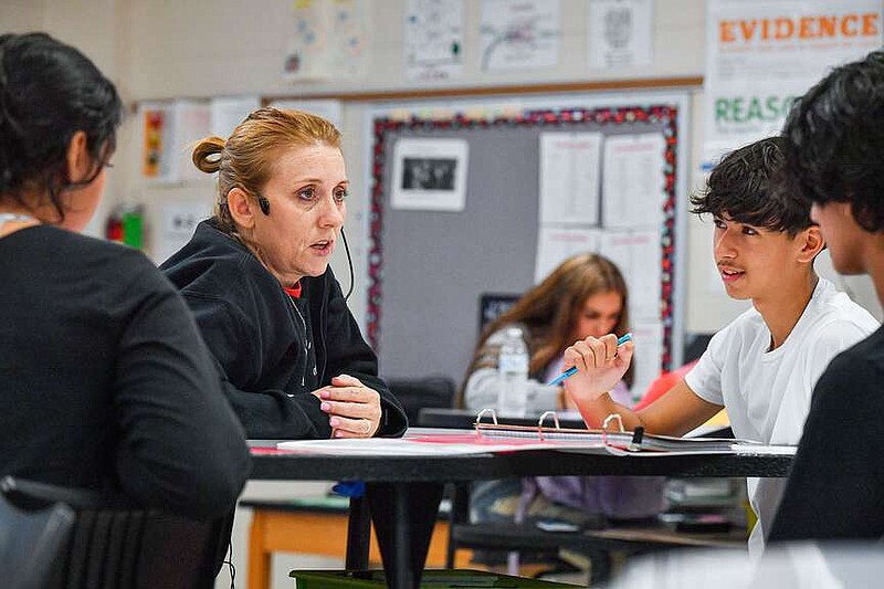 Aimee Brinkley (center), a science teacher at Fort Smith Northside High School, instructs Luis Vidal (right) and other students Sept. 1 inside her classroom in Fort Smith. The School District won't change staff salaries for the upcoming school year.
(File Photo/River Valley Democrat-Gazette/Hank Layton)