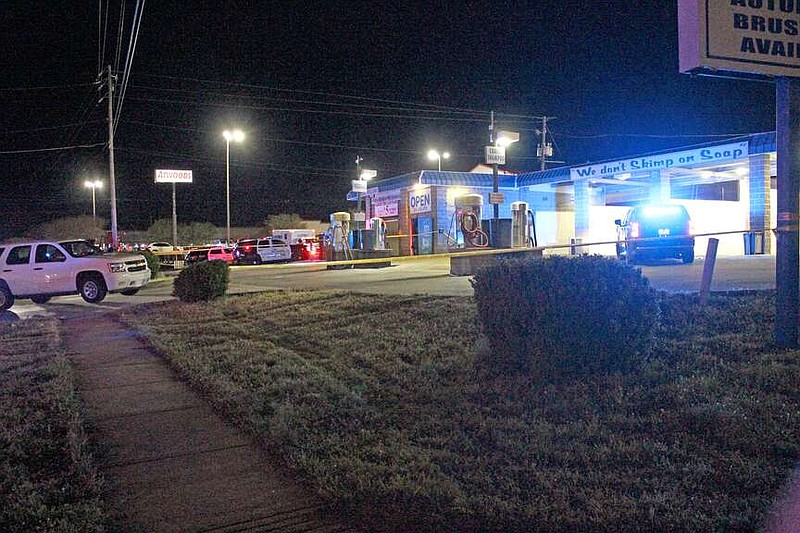 Crime scene tape is seen surrounding Albert Pike Car Wash, 2000 Albert Pike Road, late Monday night following a traffic stop at the scene where a Sherwood parolee was killed and a Hot Springs police officer wounded in an exchange of gunfire. (The Sentinel-Record/James Leigh)