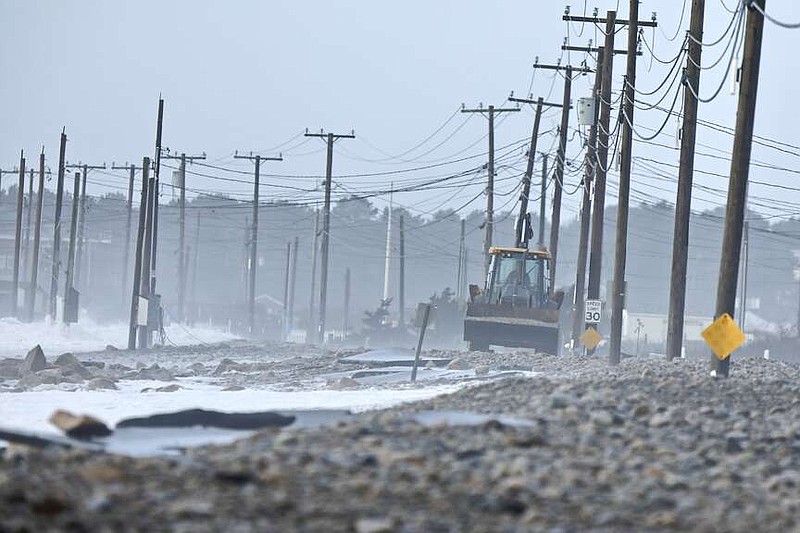 FILE - The remnants of East Beach Road are damaged after heavy overnight winds and surf battered the coastline, Wednesday, Jan. 10, 2024 in Westport, Mass.   Salisbury, Mass., is scrambling after a weekend storm washed away mountains of sand trucked in for nearly $600,000 dune that was meant to protect homes, roads and other infrastructure.  The community and other areas of Massachusetts also were hit by severe storms in January, including flooding, erosion, and infrastructure damage.  (Peter Pereira/The Standard-Times via AP)