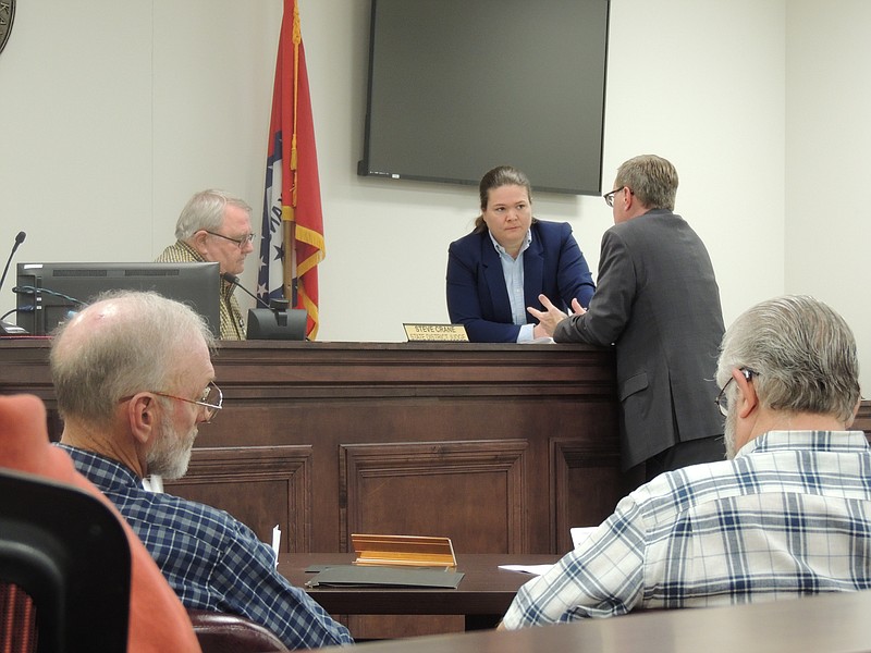Justices of the Peace for Ouachita County (in foreground) Dale Vaughan and Dennis Truelove visit while Judge Robert McAdoo tends to the lawyers in the background.