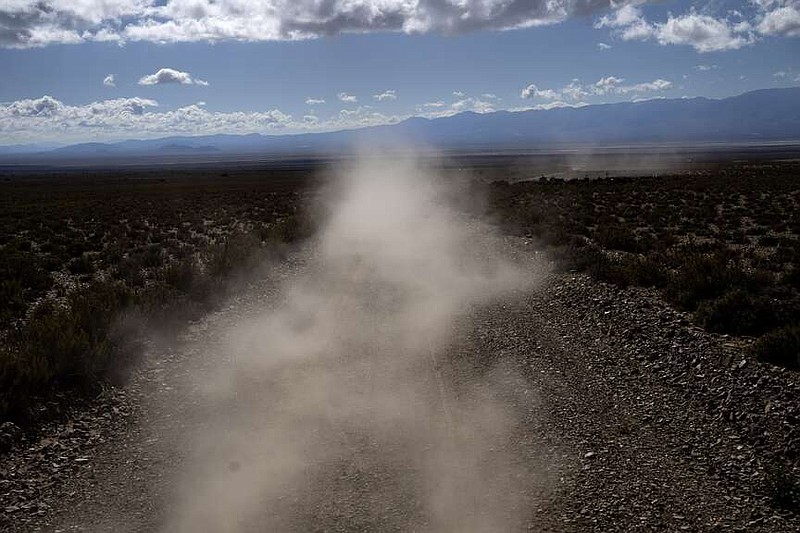 Dust is kicked up from the road as the de Callata family drives to the site where they raise livestock in Tusaquillas, Jujuy Province, Argentina, Sunday, April 23, 2023. (AP Photo/Rodrigo Abd)