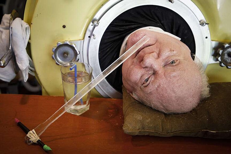 FILE - In this Friday, April 27, 2018 photo, attorney Paul Alexander looks out from inside his iron lung at his home in Dallas.  Alexander died Monday, March 11, 2024 at a Dallas hospital, said Daniel Spinks, a longtime friend. He said Alexander had recently been hospitalized after being diagnosed with COVID-19 but did not know the cause of death.  (Smiley N. Pool/The Dallas Morning News via AP)