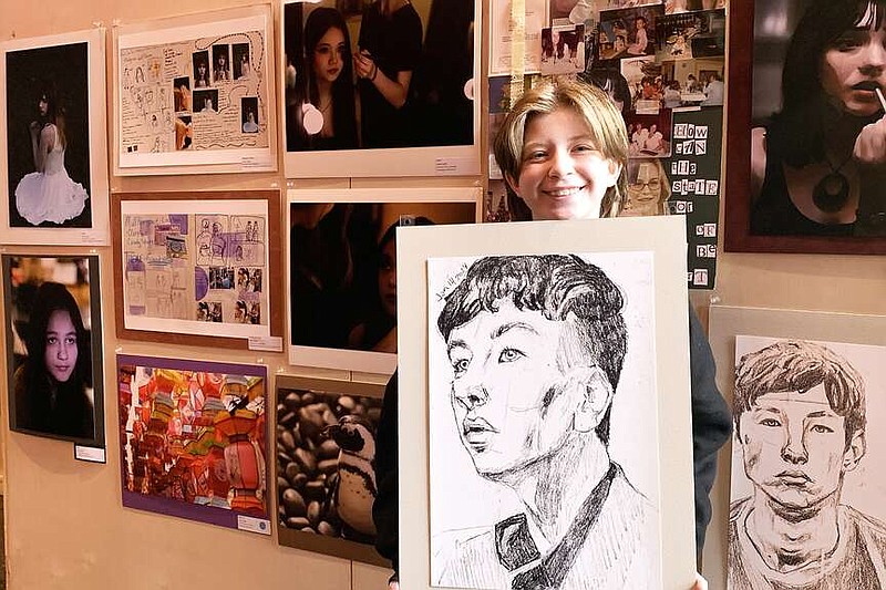 Senior AP art student Jaslyn Castle displays one of her works at Arkansas High School students' annual art show, Thursday, March 14, 2024, in Texarkana, Arkansas. Castle drew portraits of “Saltburn” star Barry Keoghan's profile after she became drawn to him in a war film she saw. (Staff photo by Mallory Wyatt)
