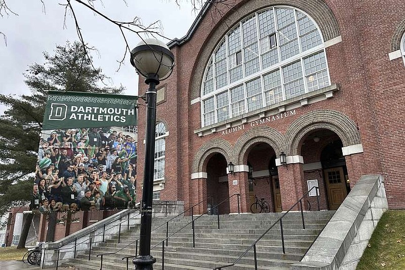 A Dartmouth Athletics banner hangs outside Alumni Gymnasium on the Dartmouth University campus in Hanover, N.H., Tuesday, March 5, 2024. Dartmouth basketball players vote Tuesday on whether to form a union. (AP Photo/Jimmy Golen)