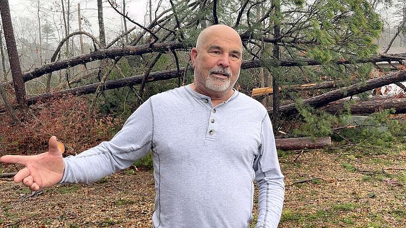 Mark Quinton, a member of the Hot Springs Village Board of Directors, discusses some of the damage he saw from Thursday's tornado. His home sustained some damage, but he said the landscape of the community will take time to recover. (The Sentinel-Record/James Leigh)