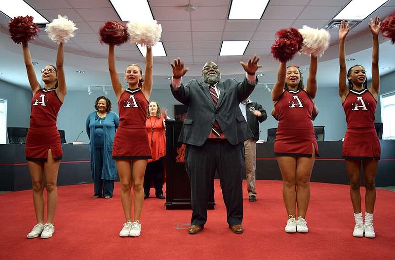 Dr. Lloyd Jackson performs a cheer with the Arkansas High School cheerleaders after a press conference introducing Jackson to the public Friday afternoon, March 15, 2024, at the Texarkana Arkansas School District Administration Building. Jackson was hired as superintendent Thursday, March 14 in a special board meeting. (Staff photo by Stevon Gamble)