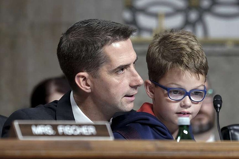 Sen. Tom Cotton, R-Ark., speaks with his son during a Senate Armed Services Committee hearing to consider Air Force Gen. CQ Brown's nomination to be chairman of the Joint Chiefs of Staff on Tuesday, July 11, 2023, on Capitol Hill in Washington. (AP Photo/Mariam Zuhaib)