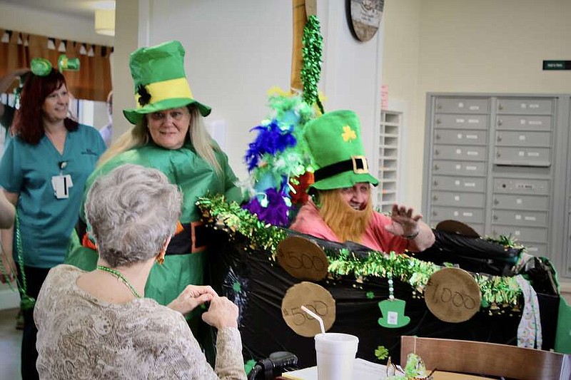 Alexa Pfeiffer/News Tribune
Wilfred Luebbert, right, is escorted by Maureen Purdy as they attend Friday's St. Patrick's Day Parade at Heisinger Bluffs.