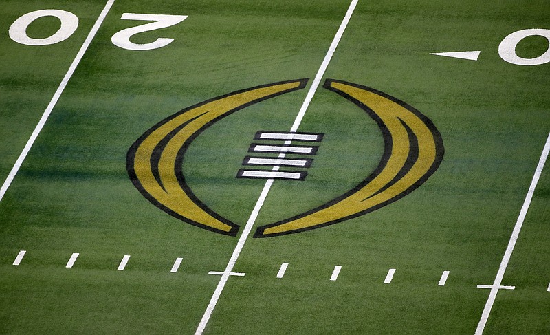 FILE - The College Football Playoff logo is shown on the field at AT&amp;T Stadium before the Rose Bowl NCAA college football game between Notre Dame and Alabama in Arlington, Texas, Jan. 1, 2021. The nine Bowl Subdivision conferences and Notre Dame reached an agreement Friday, March 15, 2024, on a six-year deal to continue the College Football Playoff through the 2031 season, a significant step that establishes a revenue-sharing plan and allows the CFP to finalize a media rights agreement.(AP Photo/Roger Steinman, File)