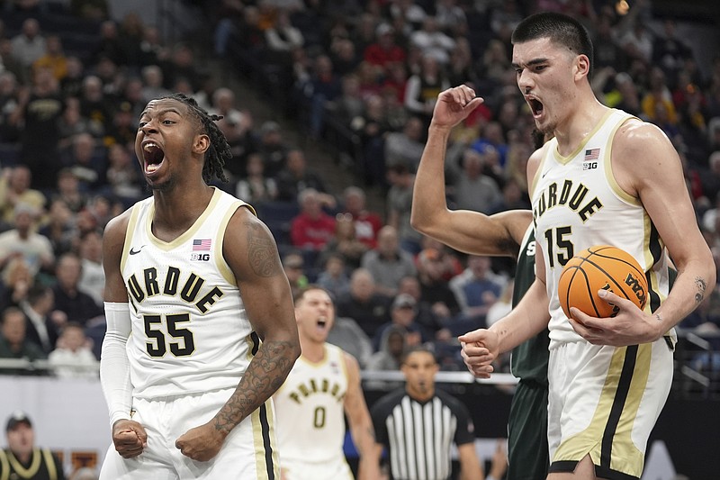 Purdue guard Lance Jones (55) celebrates after making a basket while fouled during the first half of an NCAA college basketball game against Michigan State in the quarterfinal of the Big Ten Conference tournament, Friday, March 15, 2024, in Minneapolis. At right is Purdue's Zach Edey (15). (AP Photo/Abbie Parr)