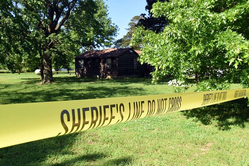 Law enforcement officers cordon off a home May 17, 2018, on Blue Jay Road in Pea Ridge in connection with a murder investigation.
(File Photo/NWA Democrat-Gazette/Flip Putthoff)