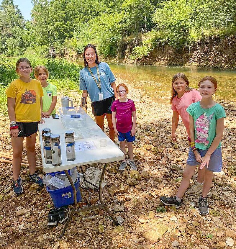 Delaney Stephens, an intern last summer at the J.B. and Johnelle Hunt Family Ozark Highlands Nature Center in Springdale, teaches children about aquatic life in streams during her internship.
(Courtesy photo/Arkansas Game and Fish)