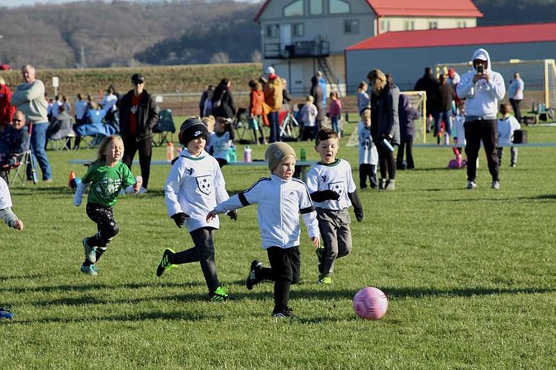 Alexa Pfeiffer/News Tribune photo: 
Pre-K soccer players run after the ball during the first game of the YMCA youth soccer season held Saturday, March 16, 2024, at the Highway 63 Soccer Complex at Jefferson City.