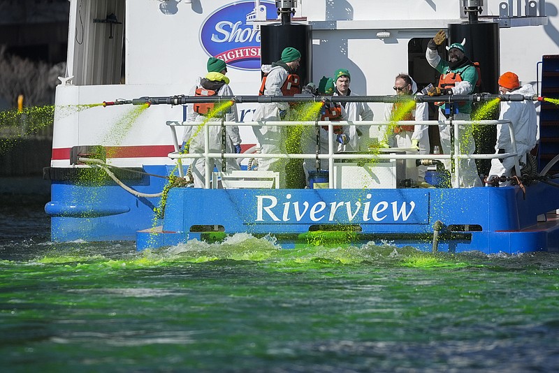 Members of the Chicago Journeymen Plumbers Local 130 dye the Chicago River green ahead of St. Patrick's Day celebrations, Saturday, March 16, 2024, in Chicago. (AP Photo/Erin Hooley)