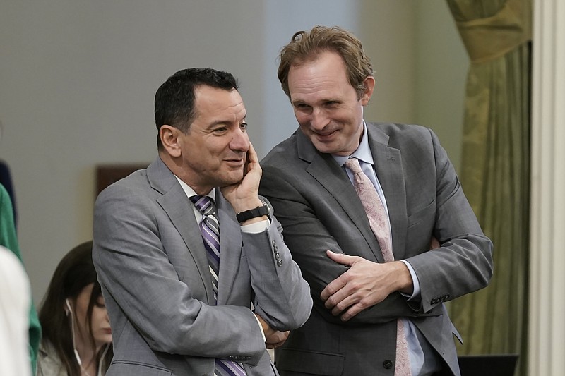 FILE -Former California Assembly Speaker Anthony Rendon, left, and Assembly Republican Leader James Gallagher talk during the Assembly session at the Capitol in Sacramento, Calif., Wednesday, Aug. 31, 2022. Rendon created the Select Committee on Happiness and Public Policy Outcomes to study how state policy can make Californians happier. (AP Photo/Rich Pedroncelli,File)