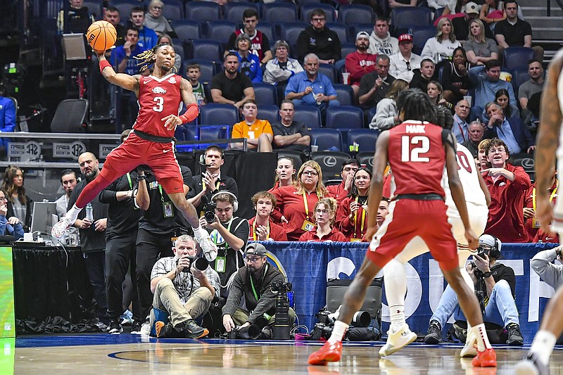 Arkansas guard El Ellis (3) saves a ball from going out of bounds, Thursday, March 14, 2024, during the first half against the South Carolina Gamecocks in the second round of the 2024 SEC Men's Basketball Tournament at Bridgestone Arena in Nashville, Tenn. (NWA Democrat-Gazette/Hank Layton)