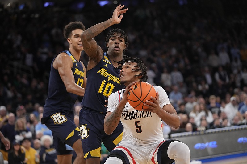 Marquette guard Zaide Lowery (10) and forward Oso Ighodaro (13) guard UConn guard Stephon Castle (5) during the first half of an NCAA college basketball game in the championship of the Big East Conference tournament, Saturday, March 16, 2024, in New York. (AP Photo/Mary Altaffer)