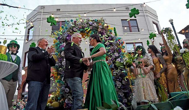 Janet Smith and Jerry Don Wheeler say "Lucky you, I do" Sunday while getting married in the middle of the First Ever 21st Annual World's Shortest St. Patrick's Day Parade Sunday on Bridge Street. (The Sentinel-Record/Lance Brownfield)