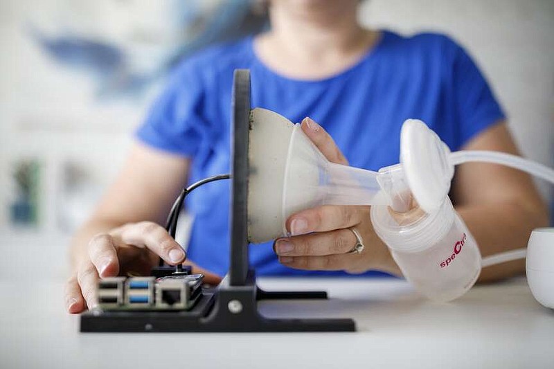 Lactation consultant Allison Tolman sets up her “Boobie Barometer,” a device she designed with an engineer to test the vacuum performance of breast pumps. (MUST CREDIT: Ivan Pierre Aguirre for The Washington Post)