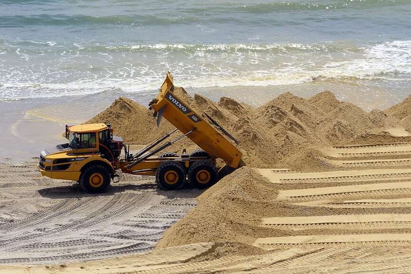 FILE - A load of sand is dumped on the beach in front of the Ocean Casino Resort in Atlantic City, N.J., Friday, May 12, 2023. The Ocean, Resorts and Hard Rock casinos want federal officials to expedite a beach replenishment project planned for 2024 so that it creates usable beaches this summer, but the U.S. Army Corps of Engineers says work might not start until the fall. (AP Photo/Wayne Parry, File)