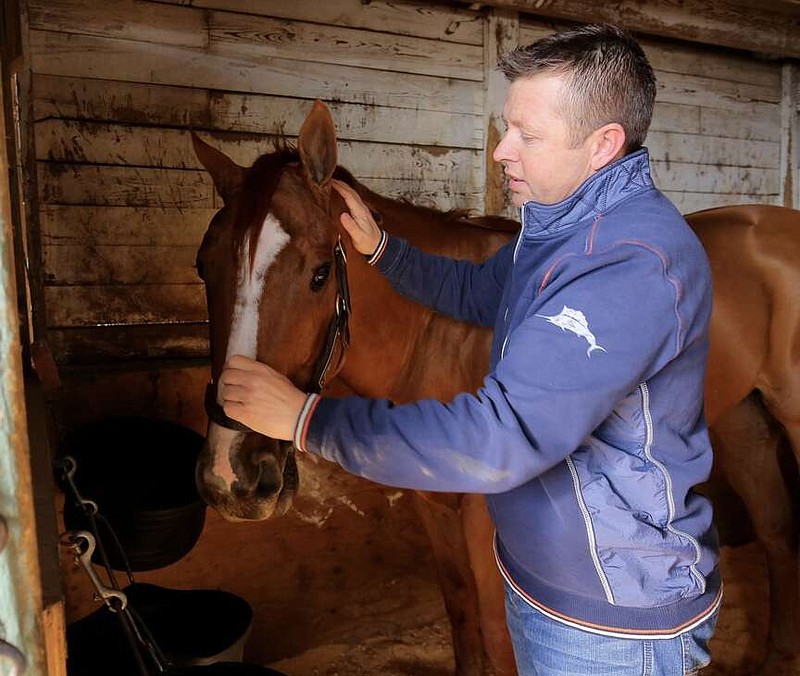 Trainer Ron Moquett is pictured with Whitmore at his stable at Oaklawn Park in this Jan. 2016 file photo. (Arkansas Democrat-Gazette/Stephen B. Thornton)
