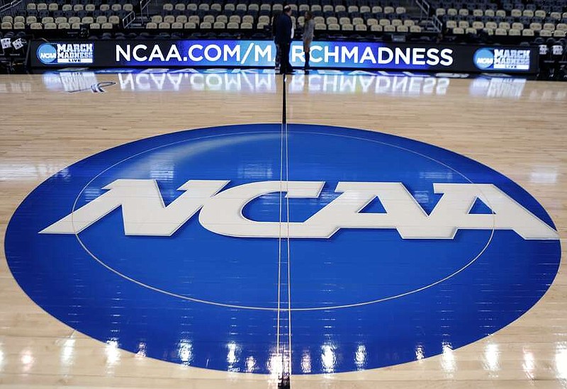 FILE - In this March 18, 2015, file photo, the NCAA logo is displayed at center court at The Consol Energy Center in Pittsburgh. More than half of Americans say they are against college athletes unionizing, though younger respondents were more supportive than older, according to a new poll from The Associated Press-NORC Center for Public Affairs Research.  (AP Photo/Keith Srakocic, File)