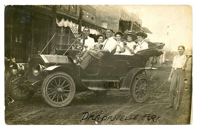 Dardanelle, circa 1910: The jauntily dressed group parked in a 1910 Buick on the dirt street were sipping sodas, apparently served by the young man balancing a tray. In the era, many drug stores boasted a soda fountain, though most likely didn't do curb service.

Send questions or comments to Arkansas Postcard Past, P.O. Box 2221, Little Rock, AR 72203