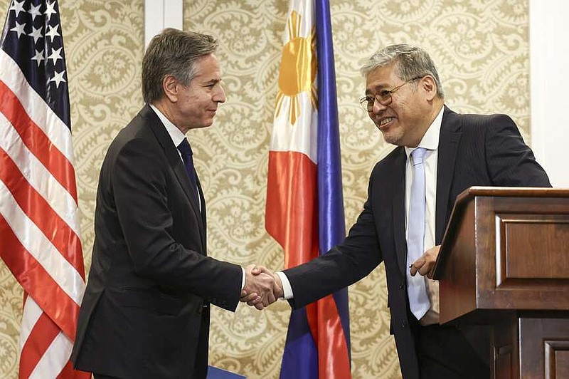 U.S. Secretary of State Antony Blinken, left, shakes hands with Philippine Foreign Affairs secretary Enrique Manalo during a joint news conference in Manila, Philippines on Tuesday March 19, 2024. (Eloisa Lopez/Pool Photo via AP)