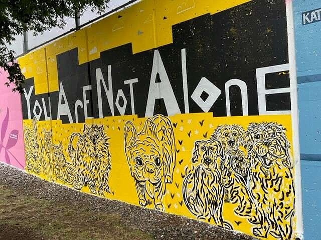 Artist Lea Craigie-Marshall created a mural featuring a mental health message for the NoMa in Color arts celebration in Washington in September 2023. (Donna St. George/The Washington Post)