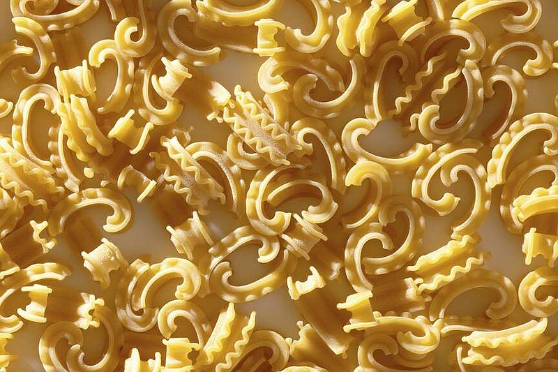 This image shows a new pasta shape called cascatelli, created by food writer and podcaster Dan Pashman. Pashman's “Anything's Pastable” features dishes using 34 different pasta shapes, but especially features his cascatelli, a graceful, ruffled-edged curved shape that resembles a quotation mark. Time magazine declared cascatelli one of 2021's best inventions. (Scott Bleicher via AP)
