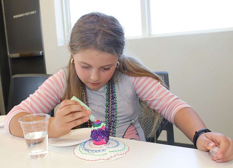 Lynn Kutter/Enterprise-Leader
Children attending Kid's Corner at Farmington Public Library on Tuesday, March 19 learned about the history of Faberge eggs and then were able to create their own egg with decorations provided by the library. Noelle Bree, 9, of Fayetteville, works on her Faberge egg. Kid's Corner is held 3:15 p.m. Tuesdays and is best for ages 5-8.