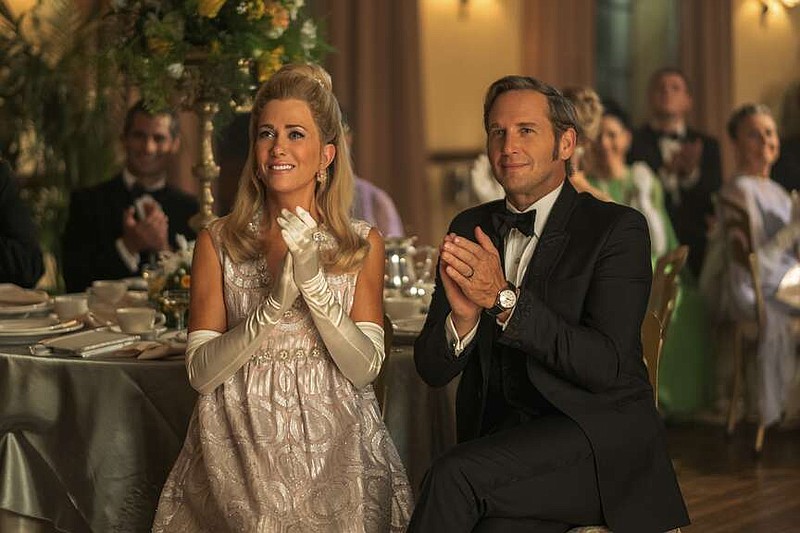 This image released by Apple TV+ shows Kristen Wiig, left, and Josh Lucas in a scene from the series "Palm Royale." (Apple TV+ via AP)