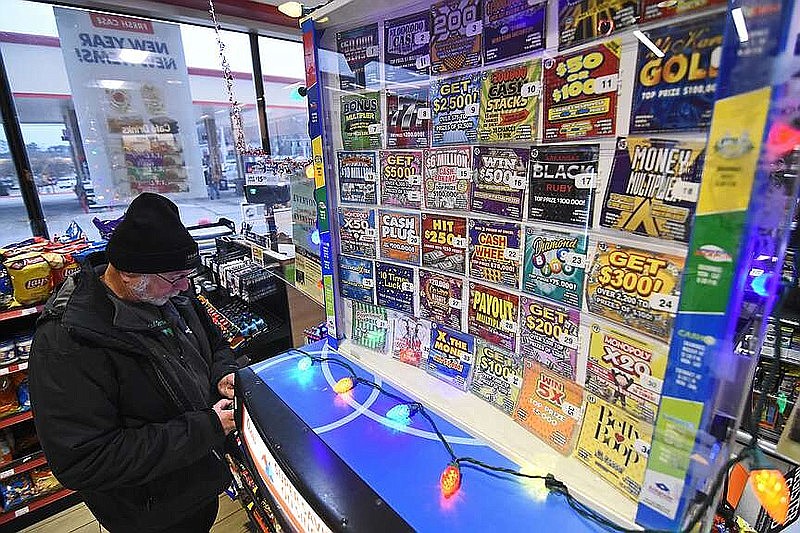 John Foster of Maumelle buys a lottery ticket Jan. 12, 2022, at the Murphy Express at the corner of Chenal Parkway and Markham Street in Little Rock. (File Photo/Arkansas Democrat-Gazette/Staci Vandagriff)