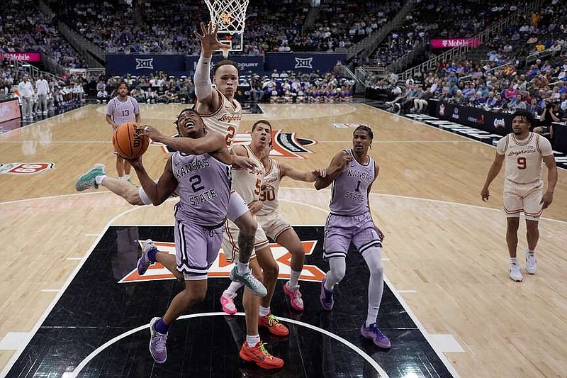 Kansas State guard Tylor Perry (2) looks to shoot under pressure from Texas guard Chendall Weaver (2) during the first half of Wednesday's game in Kansas City, Mo. (AP Photo/Charlie Riedel)