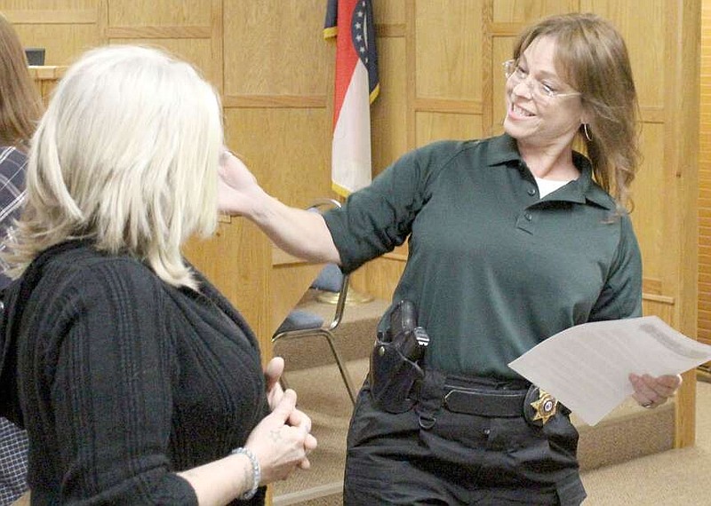 Daniel Bereznicki/McDonald County Press
Detective Lorie Howard (right) embraces Danielle Pixler of Topeka, Kan., before a press conference on March 21 in which Howard and other investigators announced the solving of Pixler's sister's murder, a 30-year-old cold case. Shauna Garber was killed in 1990 by Talfey Reeves, investigators said.